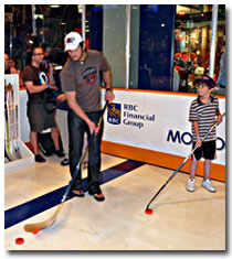 NHL star Alexander Ovechkin tests his skills in the Source For Sports Shoot Out game.