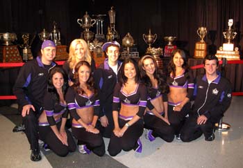 Members of the LA Kings Ice Crew pose for a photo in front of the National Hockey League trophies during draft weekend in Los Angeles.