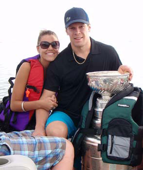 Jordan Hendry and his girlfriend pose for a photo with the Stanley Cup on Lost Mountain Lake in Saskatchewan.