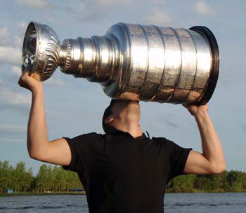 Jordan Hendry sharing a moment with the Stanley Cup at his lake house along Lost Mountain Lake.