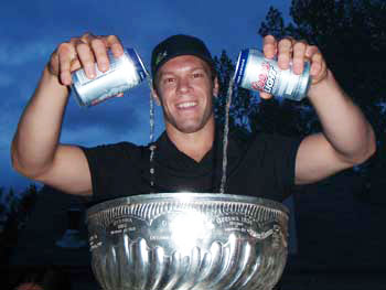 Jordan Hendry filling up the Stanley Cup with a few cold beverages.