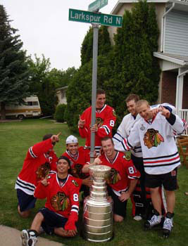 Kris Versteeg and friends pose for a photo with the Stanley Cup following their street hockey game.