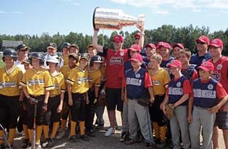 Patrick Sharp showing off the Stanley Cup with two little league baseball teams