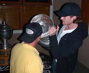Duncan Keith lets a friend enjoy a refreshing drink from the bowl of the Stanley Cup.