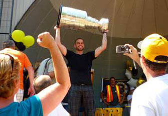 Nathan Horton proudly hoisting the Stanley Cup upon it's arrival from a long day of travel.
