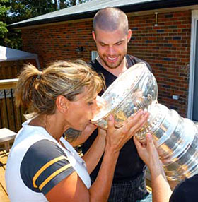 Nathan Horton helping his mother Georgina enjoy a drink from the Stanley Cup.