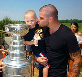 Nathan Horton and son Dylan sharing a moment with the Stanley Cup.