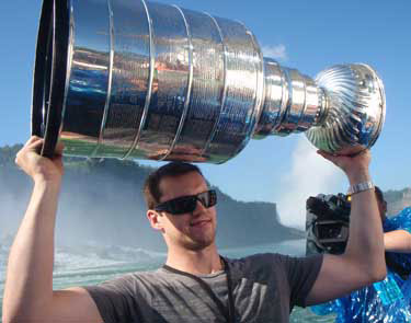 Dan Paille proudly hoisting the Stanley Cup following a ride on Maid of the Mist in Niagara Falls.