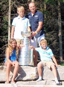 Marc Savard and his children Isabella, Zachary and Tyler pose for a photo with the Stanley Cup.