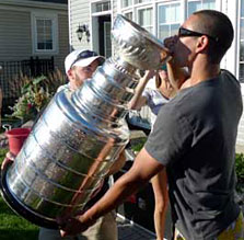 Chris Kelly takes a sip from the most famous trophy in all of sports.