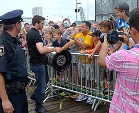 Patrice Bergeron and the Stanley Cup make their past the crowd at the Pavillon Espace 400e Bell in Quebec City.