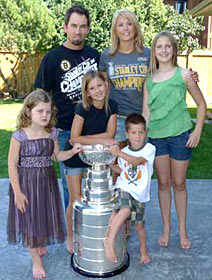 Shane Hnidy and family sharing a moment with the Stanley Cup at their home in Neepawa, MB.