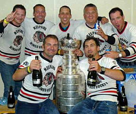 Shane Hnidy and with family and friends celebrating with the Stanley Cup in their old minor hockey dressing room at the Yellowhead Centre in Neepawa, MB.