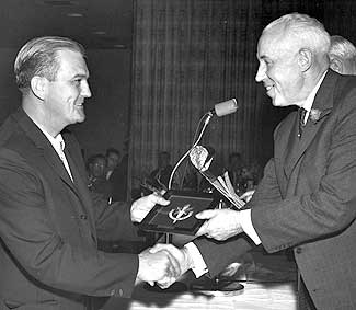 Bill Durnan is presented his Hockey Hall of Fame inductee plaque by former NHL President Clarence Campbell at the 1964 Induction Ceremony