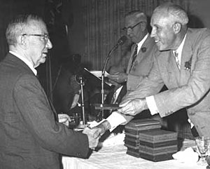 In 1945 Art Ross was part of the first group of players elected to the newly founded Hockey Hall of Fame. Here he receives his Hockey Hall of Fame Induction plaque from Clarence Campbell during a ceremony held in Toronto.