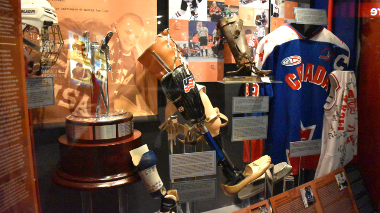 A section of 'The Changing Face of Hockey - Diversity in Our Game' exhibit features items from Para Hockey including prosthetic limbs, jerseys, trophies and more.