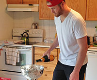 Preparing to celebrate, Bryan Bickell pours champagne into the Stanley Cup.