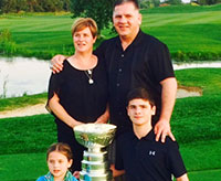 The Bernard family pose for a photo with the Stanley Cup on the 18th green at Willow Valley Golf Club