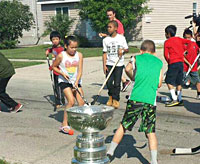 Andrew Shaw proudly hoists the Stanley Cup aboard his boat near Belleville, Ontario.