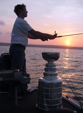 Chris Huffine, Carolina Hurricanes' video co-ordinator, fishing with the Stanley Cup