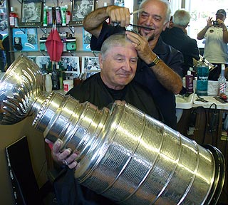 Carolina Hurricanes Scout Tony MacDonald with the Stanley Cup at Franco's Barber Shop in Guelph, Ontario