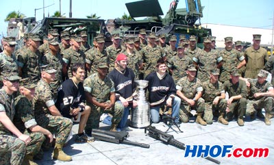 The Anaheim Ducks' Chris Kunitz, Dustin Penner and Scott Niedermayer pose with military and civilian personnel at Camp Pendleton Military Base.