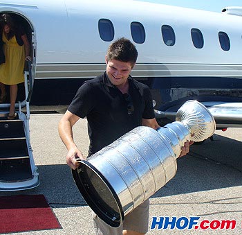 The Anaheim Ducks' Chris Kunitz retrieves the Stanley Cup after his flight from Big Rapids, Michigan to Regina, Saskatchewan