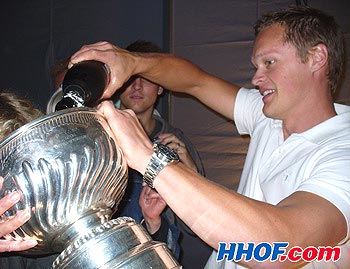 Anaheim Ducks centre Samuel Pahlsson fills the bowl of the Stanley Cup with champagne at his backyard party in Sweden
