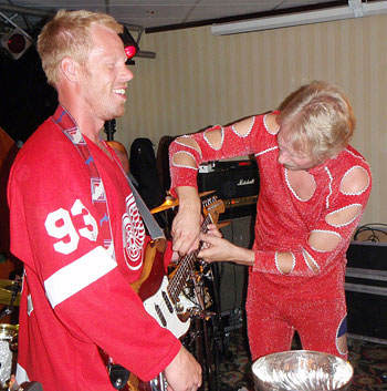 Johan Franzen has his guitar fine tuned for his performance during his Stanley Cup party in Vetlanda, Sweden