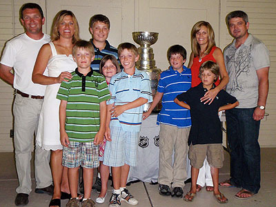 The Detroit Red Wings' Todd McLellan and members of his family gather around the Stanley Cup for a few photos.