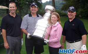 Penguins GM Ray Shero showing off the Stanley Cup to members of his foursome during the team's golf tournament.