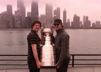 Colin Fraser and Brent Seabrook pose with the Stanley Cup during a lunch hour boat cruise.
