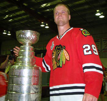 An emotional Bryan Bickell sharing a moment with the Stanley Cup at the Orono Arena.