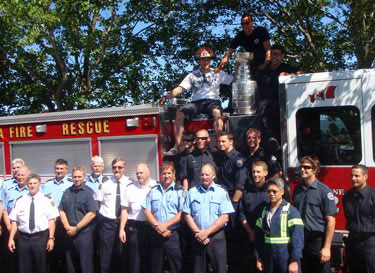 Brent Seabrook and the Stanley Cup with members of the Delta Fire and Rescue team.