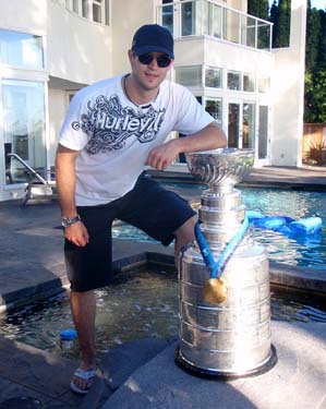 Brent Seabrook sharing a moment with the Stanley Cup and his Olympic Gold Medal from Vancouver.