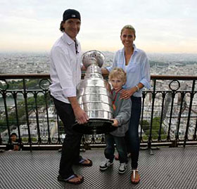 Cristobal Huet posing for a picture at the top of the Eiffel Tower with his wife Corine and one of his son's Ewan in Paris