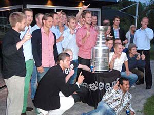 Niklas Hjalmarsson and some of his former teammates getting their picture taken with Lord Stanley