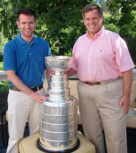 Rocky Wirtz sharing a moment with his son and the Stanley Cup
