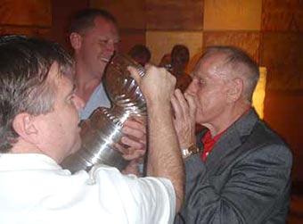 Members of the Boston Bruins scouting department enjoying their time with the Stanley Cup.