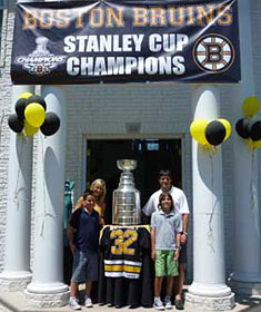 Don Sweeney and family sharing a moment with the Stanley Cup outside the home of friends