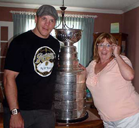 Shawn Thornton and his mother Christine sharing a moment with the Stanley Cup at their family home