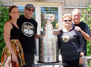 Shawn Thornton along with wife Erin and her parents posing for a few pictures with the Stanley Cup