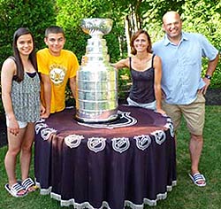 Peter Chiarelli and his family sharing a moment with the Stanley Cup at their home in Lexington, MA.