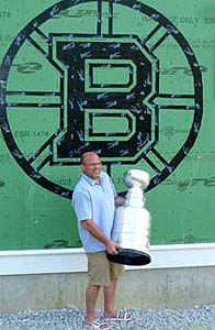 Peter Chiarelli and the Stanley Cup posing for a photo in front of his neighbours house in Lexington, MA.