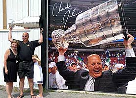Claude Julien proudly hoisting Lord Stanley along with family while spending some time at his parents home in Navan, ON.