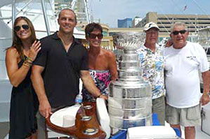 Dennis Seidenberg and his wife Rebecca sharing a moment with the Stanley Cup along with family and friends.