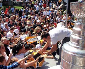 Brad Marchand taking time to sign some autographs for fans.