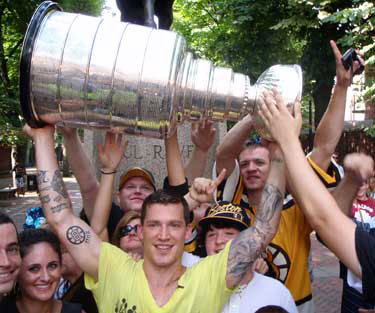 Andrew Ference proudly hoisting the Stanley Cup during a flash mob.