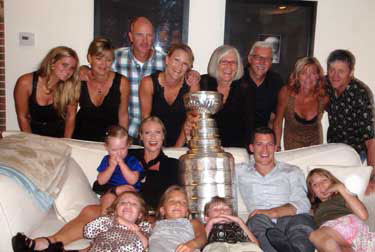 Andrew Ference along with family and friends sharing a moment Lord Stanley.