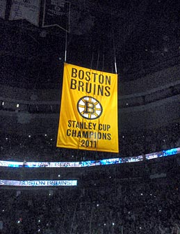 The 2011 Stanley Cup championship banner is raised to the rafters of the TD Garden.